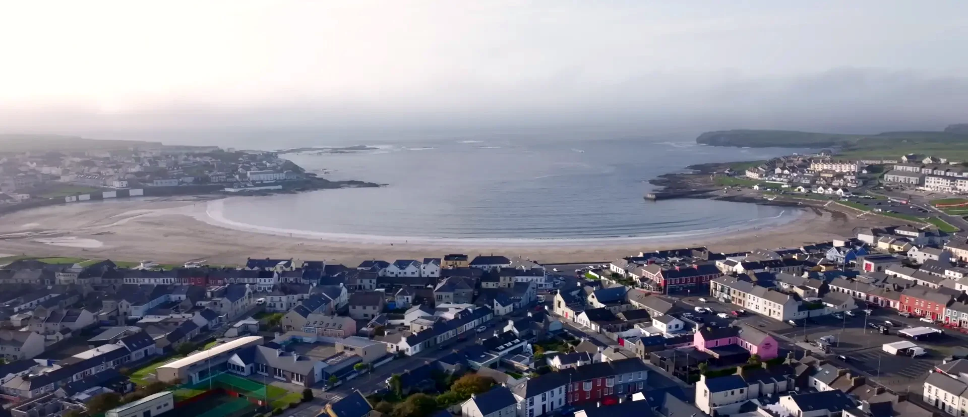 Genuine aerial photograph of the whole Kilkee horseshoe bay, town rooftops and Atlantic headlands