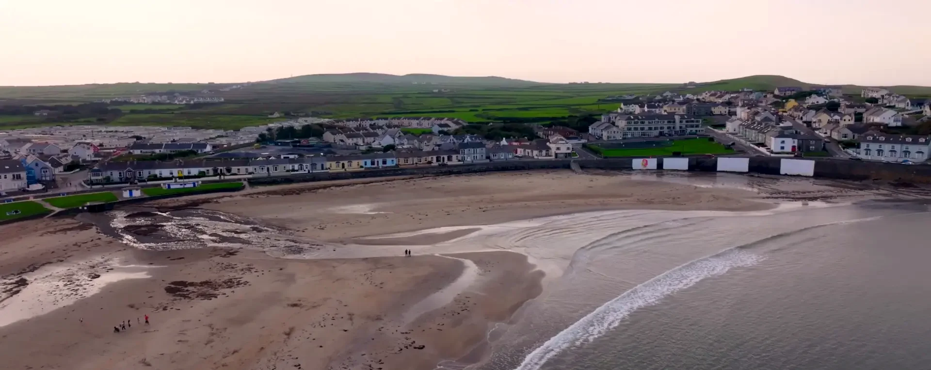 Kilkee beach at low tide, with the promenade and town beyond